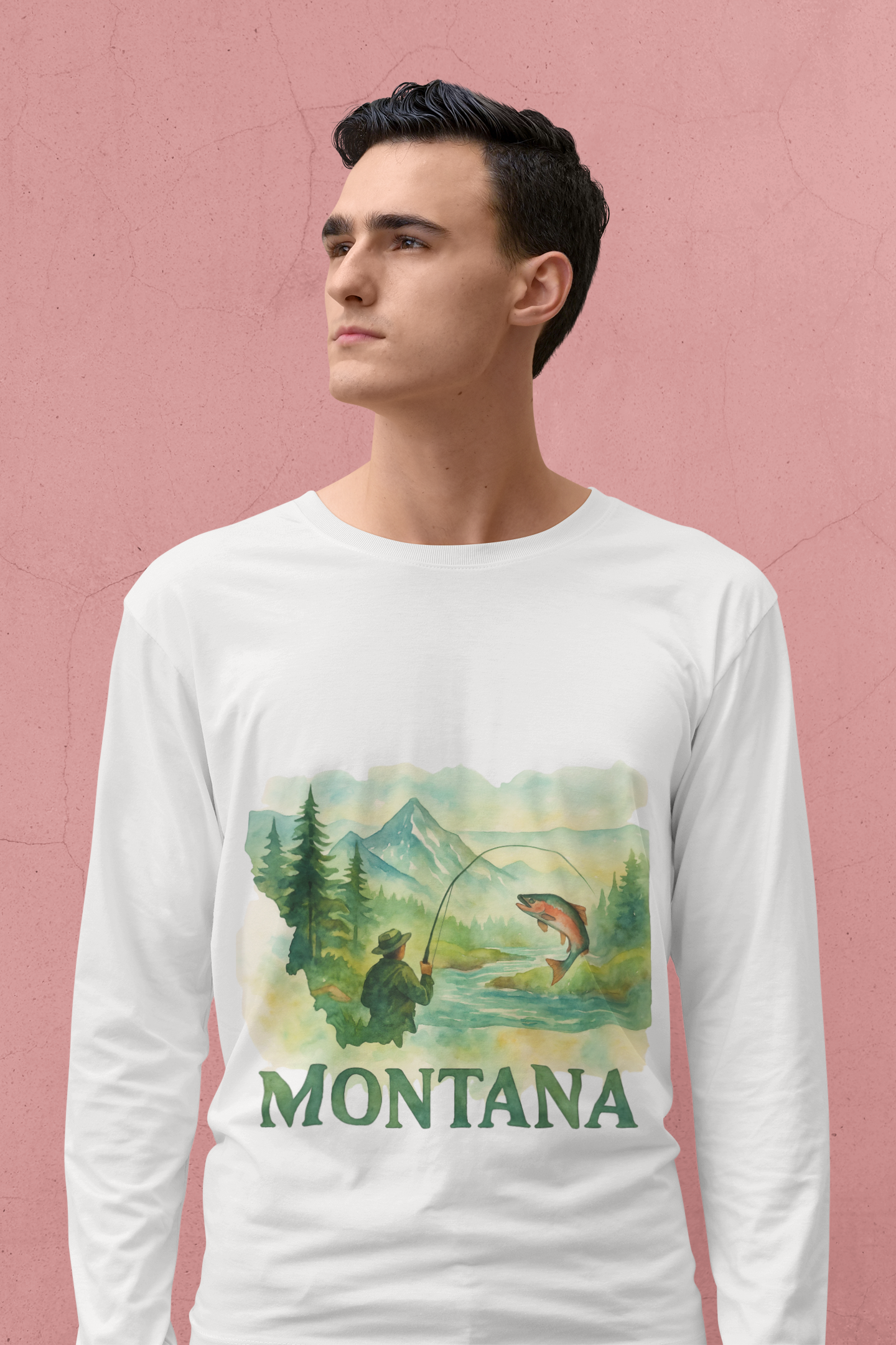 Montana Fishing Long Sleeve Tee with nature-inspired design, worn by a man standing against a pink background.