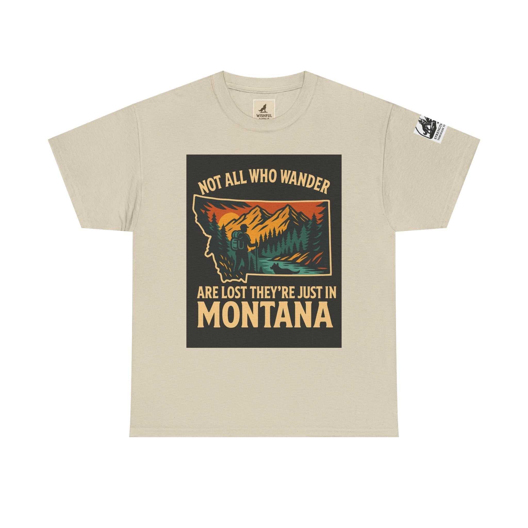 Soft beige t-shirt with "Not All Who Wander Are Lost They're Just in Montana" print in vibrant nature-inspired colors.